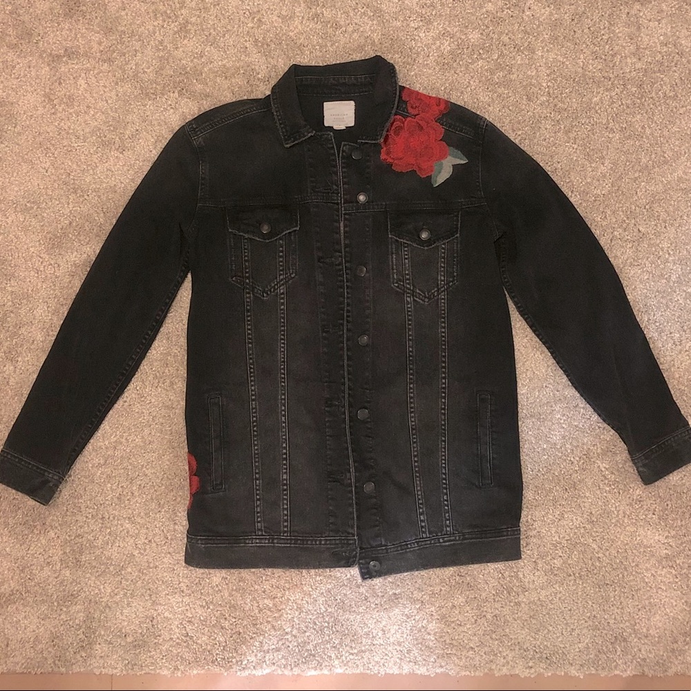 Black Jean jacket with embroidered red flowers.